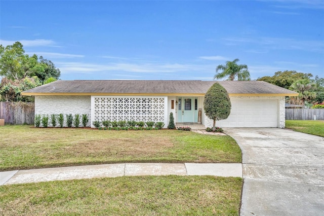 single story home with fence, a front lawn, driveway, and a garage