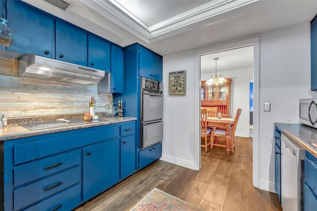 kitchen with dishwashing machine, stainless steel microwave, under cabinet range hood, double wall oven, and blue cabinetry