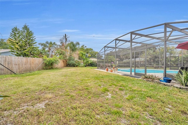 view of yard with a fenced backyard, a fenced in pool, and a lanai