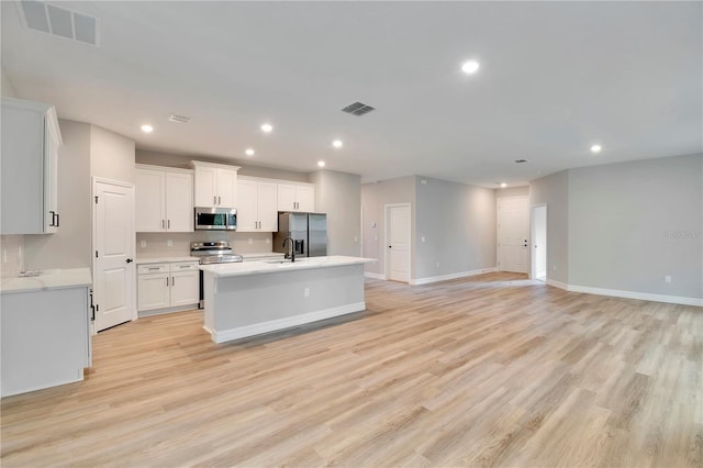 kitchen featuring recessed lighting, appliances with stainless steel finishes, a sink, and visible vents