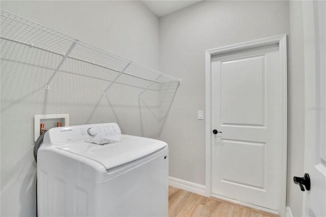 laundry room with washer / clothes dryer, laundry area, baseboards, and light wood-type flooring