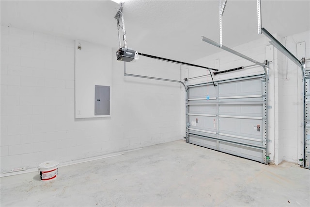 garage with a garage door opener and electric panel