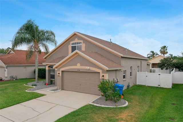 29704 Eagle Station Dr, Wesley Chapel, FL 33543 - mediterranean / spanish home with concrete driveway, an attached garage, stucco siding, and fence