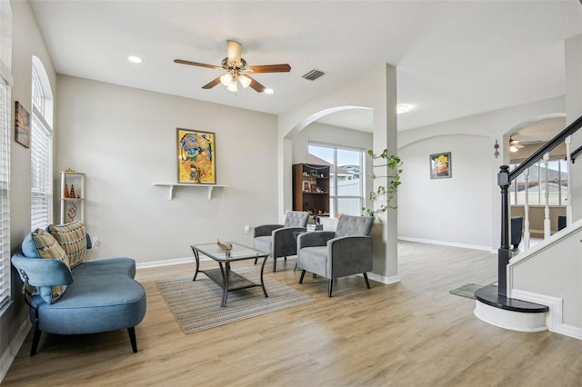 29704 Eagle Station Dr, Wesley Chapel, FL 33543 - living area with a ceiling fan, arched walkways, wood finished floors, stairs, and recessed lighting