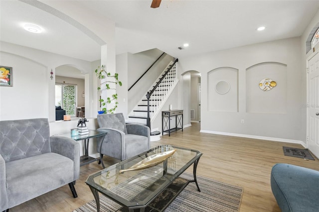 29704 Eagle Station Dr, Wesley Chapel, FL 33543 - living room featuring arched walkways, baseboards, wood finished floors, stairs, and recessed lighting