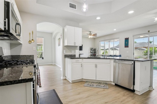 29704 Eagle Station Dr, Wesley Chapel, FL 33543 - kitchen featuring a ceiling fan, stainless steel appliances, white cabinetry, visible vents, and arched walkways