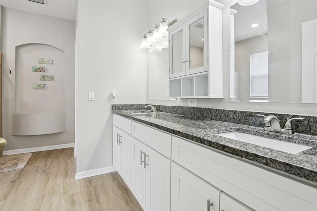 29704 Eagle Station Dr, Wesley Chapel, FL 33543 - bathroom with a sink, double vanity, baseboards, and wood finished floors