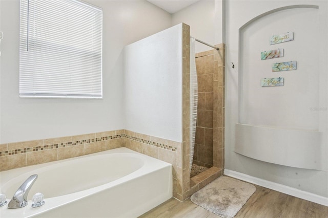 29704 Eagle Station Dr, Wesley Chapel, FL 33543 - full bathroom with wood finished floors, a bath, and a tile shower