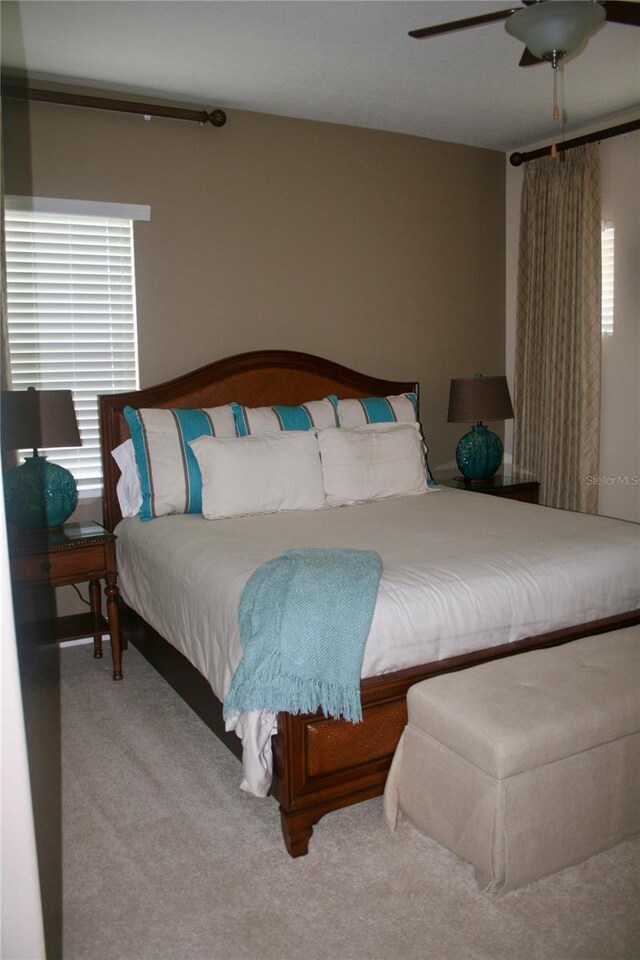 carpeted bedroom with ceiling fan