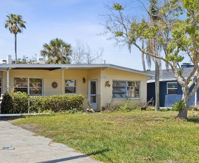 15406 2nd St E, Madeira Beach, FL 33708 - view of front of property with a front lawn