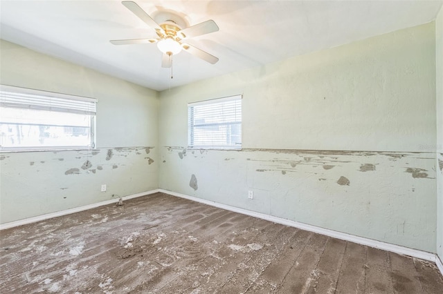 15406 2nd St E, Madeira Beach, FL 33708 - empty room with a ceiling fan, baseboards, and wood finished floors