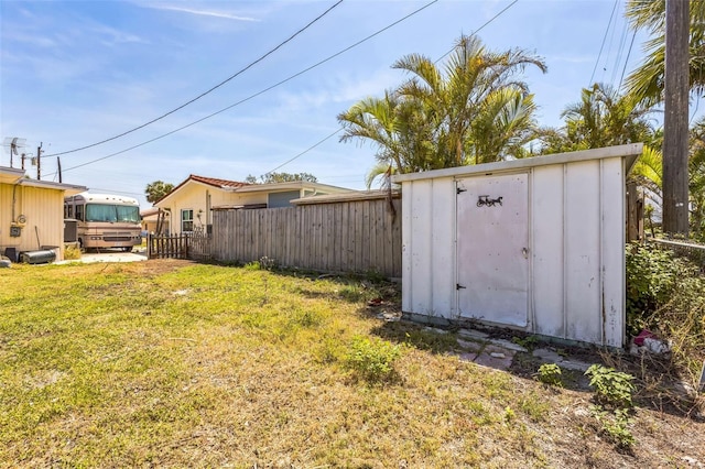 15406 2nd St E, Madeira Beach, FL 33708 - view of yard with an outdoor structure, fence, and a shed