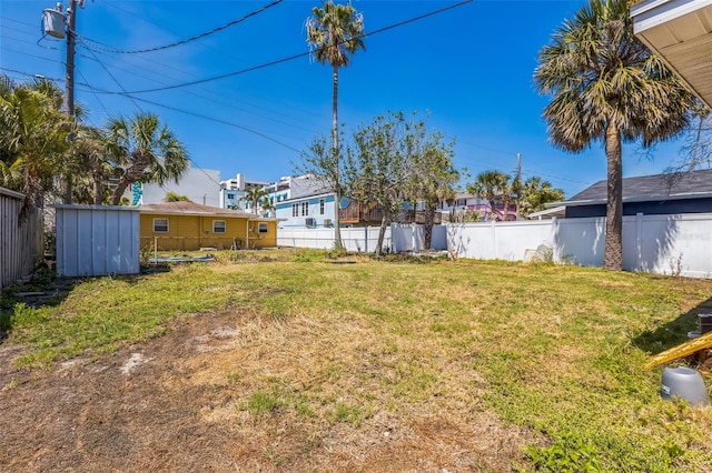 15406 2nd St E, Madeira Beach, FL 33708 - view of yard with a storage unit, an outdoor structure, fence, and a residential view