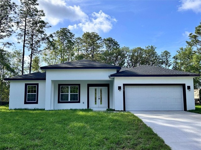 view of front facade featuring an attached garage, a front lawn, stucco siding, and concrete driveway