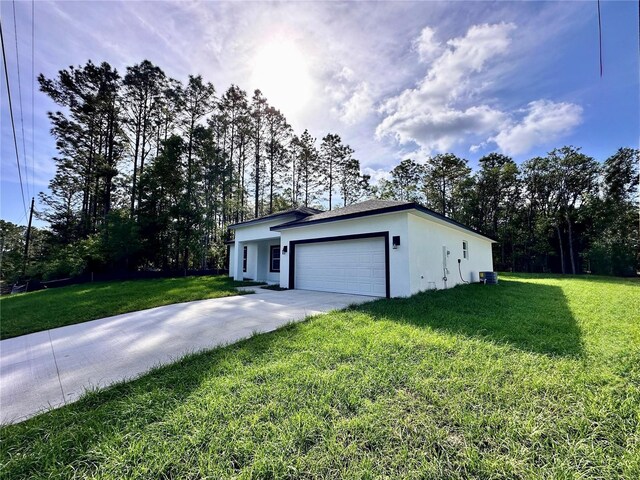 view of home's exterior with an attached garage, a lawn, stucco siding, and concrete driveway