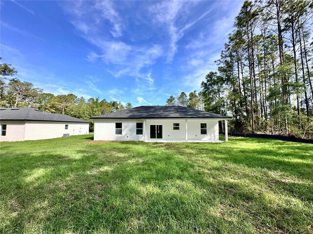 back of house with a yard