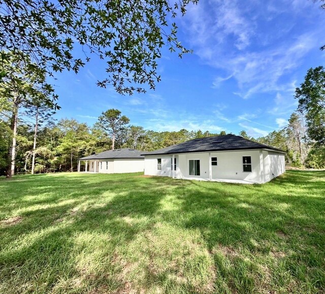 back of house featuring a yard