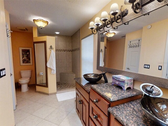 full bath featuring vanity, toilet, baseboards, walk in shower, and tile patterned floors