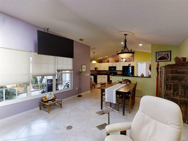 living room featuring baseboards, light tile patterned flooring, vaulted ceiling, and visible vents