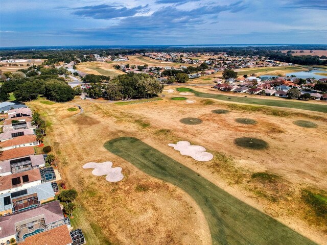 aerial view with a water view and view of golf course
