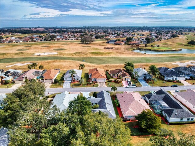 bird's eye view with a water view, golf course view, and a residential view