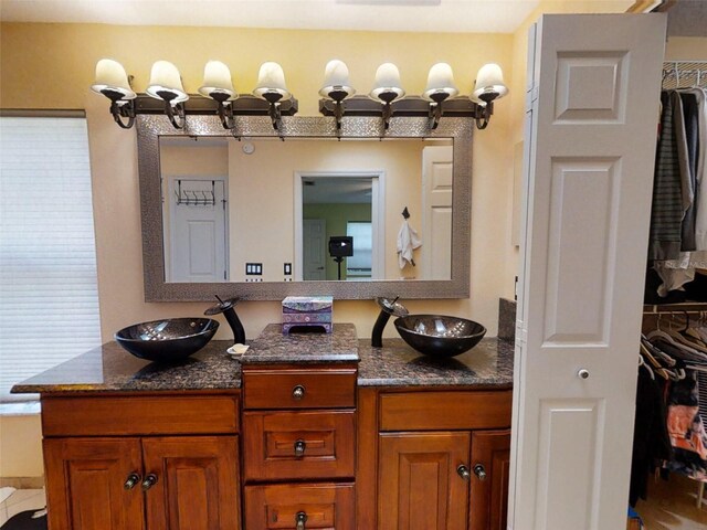 bathroom with a sink and double vanity