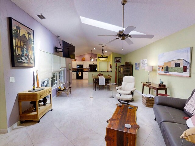 living area featuring baseboards, ceiling fan, vaulted ceiling, and visible vents