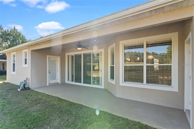 23533 Valderama Ln, Sorrento, FL 32776 - rear view of property featuring a patio, a ceiling fan, a lawn, and stucco siding