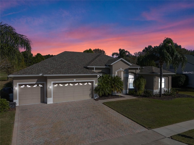 23533 Valderama Ln, Sorrento, FL 32776 - single story home featuring decorative driveway, an attached garage, a front yard, and stucco siding