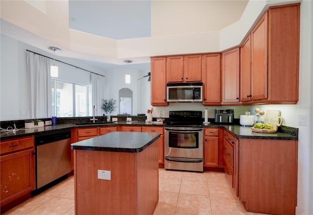 23533 Valderama Ln, Sorrento, FL 32776 - kitchen featuring a center island, a sink, appliances with stainless steel finishes, and light tile patterned flooring