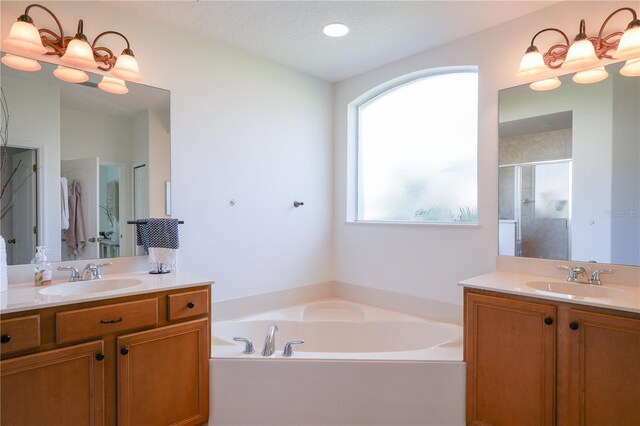 23533 Valderama Ln, Sorrento, FL 32776 - bathroom with a garden tub, a sink, two vanities, and a shower stall