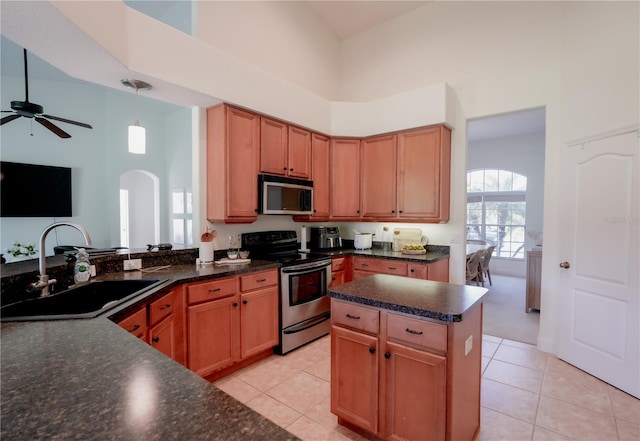 23533 Valderama Ln, Sorrento, FL 32776 - kitchen with ceiling fan, a towering ceiling, arched walkways, a sink, and stainless steel appliances