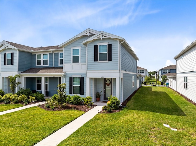 view of front of home with covered porch and a front lawn