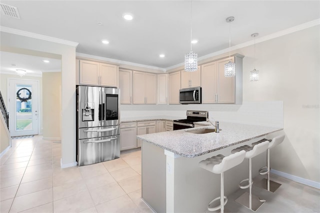 kitchen with crown molding, appliances with stainless steel finishes, a sink, a peninsula, and visible vents