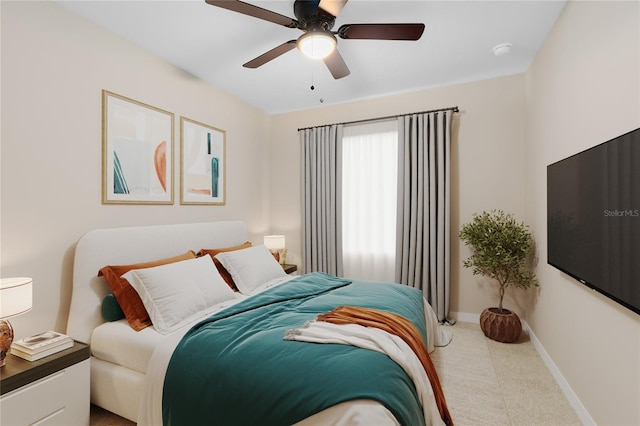 carpeted bedroom with baseboards and ceiling fan