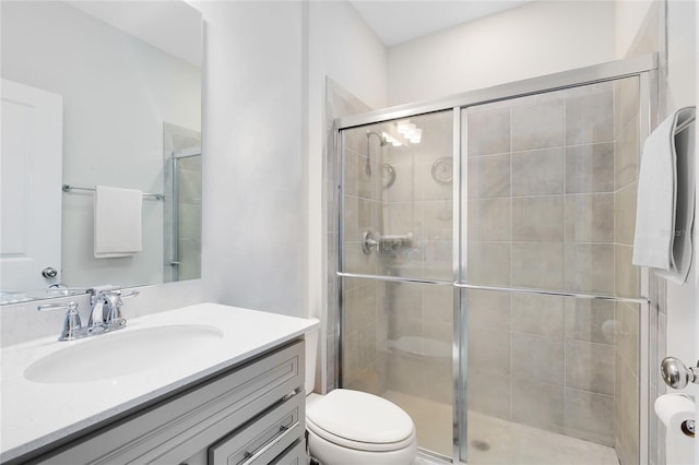 full bathroom featuring vanity, toilet, and a stall shower