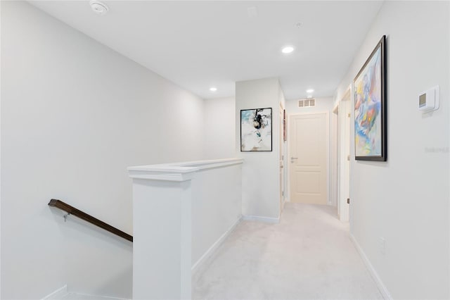 corridor with visible vents, light colored carpet, baseboards, an upstairs landing, and recessed lighting