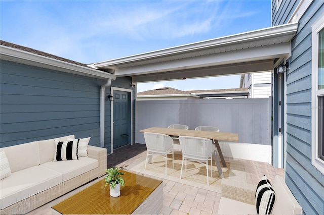 view of patio featuring fence, an outdoor living space, and outdoor dining space