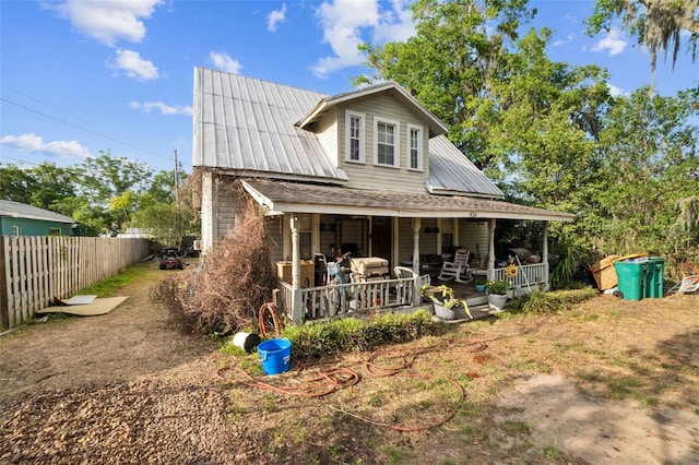 419 Palm Ave, Eustis, FL 32726 - rear view of house with fence and metal roof