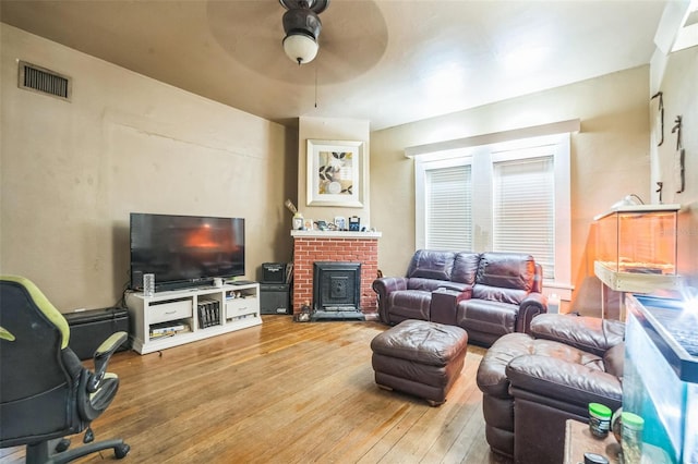 419 Palm Ave, Eustis, FL 32726 - living area with ceiling fan, a brick fireplace, hardwood / wood-style flooring, and visible vents