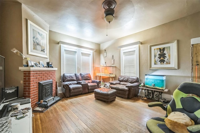 419 Palm Ave, Eustis, FL 32726 - living area featuring a brick fireplace, ceiling fan, and wood-type flooring