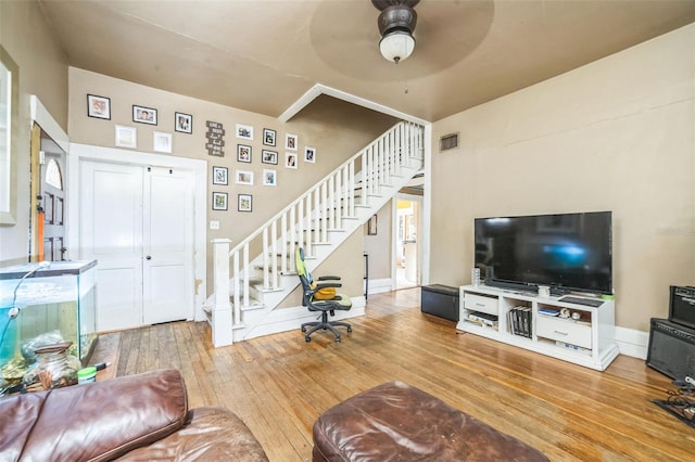 419 Palm Ave, Eustis, FL 32726 - living area with stairs, a ceiling fan, baseboards, visible vents, and hardwood / wood-style flooring
