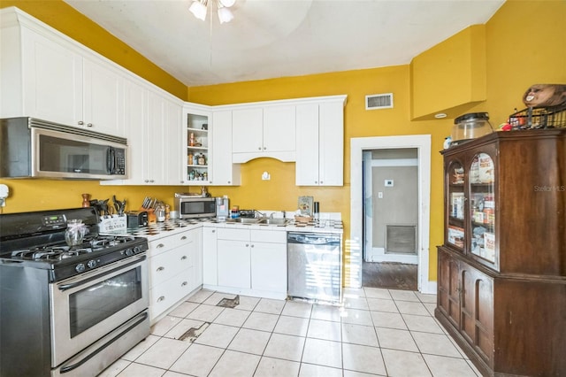 419 Palm Ave, Eustis, FL 32726 - kitchen with a sink, white cabinets, stainless steel appliances, and visible vents