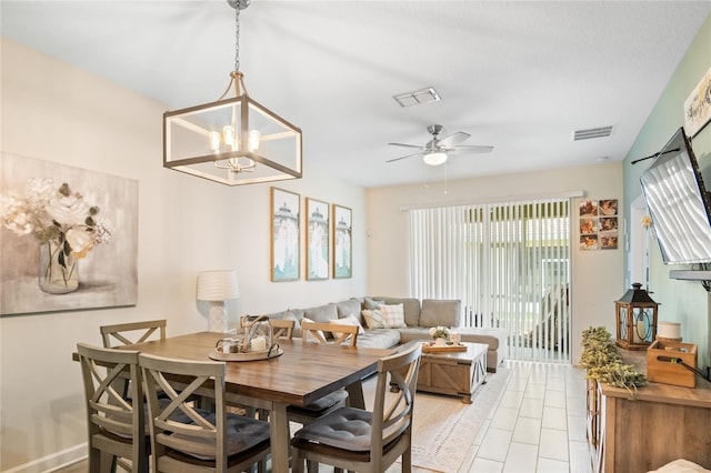 dining space featuring visible vents and ceiling fan with notable chandelier