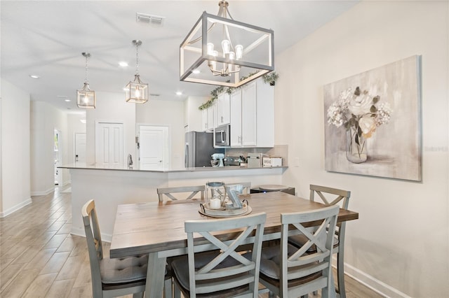 dining room with visible vents, recessed lighting, baseboards, and light wood finished floors