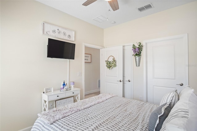 bedroom featuring baseboards, visible vents, and ceiling fan