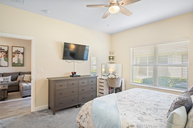 carpeted bedroom featuring baseboards and ceiling fan