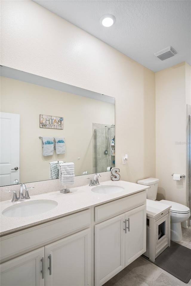 full bath with double vanity, visible vents, a sink, and a stall shower