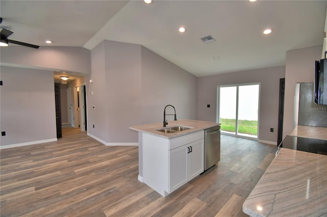 kitchen with a sink, dishwasher, lofted ceiling, baseboards, and light wood-style flooring
