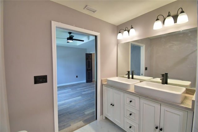 full bathroom featuring double vanity, marble finish flooring, and ceiling fan